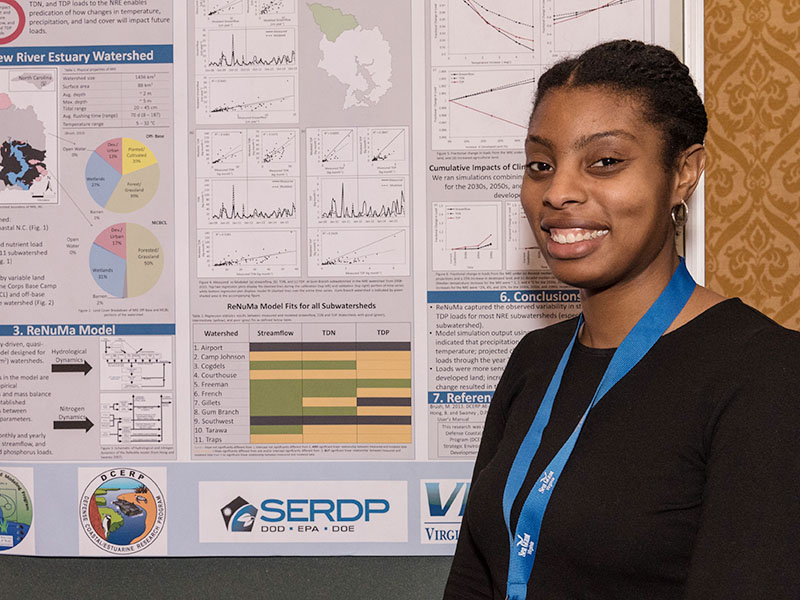 A coastal management fellow with her research poster.