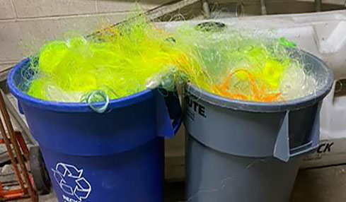 Monofilament that has been collected for recycling is stored in two 55-gallon trash cans.